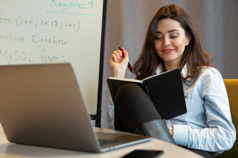 Mentor holding notebook in class